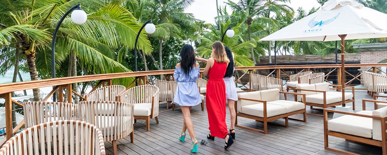 Beautiful shot of three guests enjoying the view at the rooftop bar and lounge at Angel Beach Unawatuna.